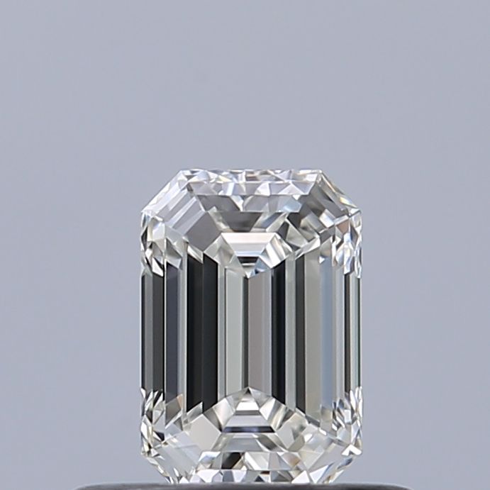 Emerald cut diamond with brilliant facets, showcasing clarity and sparkle against neutral background